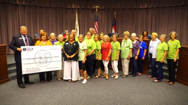 UGA Extension Master Gardener Volunteers of Cobb County Presenting A Honorary Check Valuing Their Volunteer Hours In Cobb At Over $560,000 To The Cobb Board Of Commissioners    